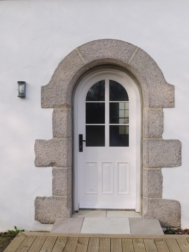 Arched White Entrance Door With Stone Surround And Glazing Panels Exterior Doors Trinity Joinery Jersey 2500