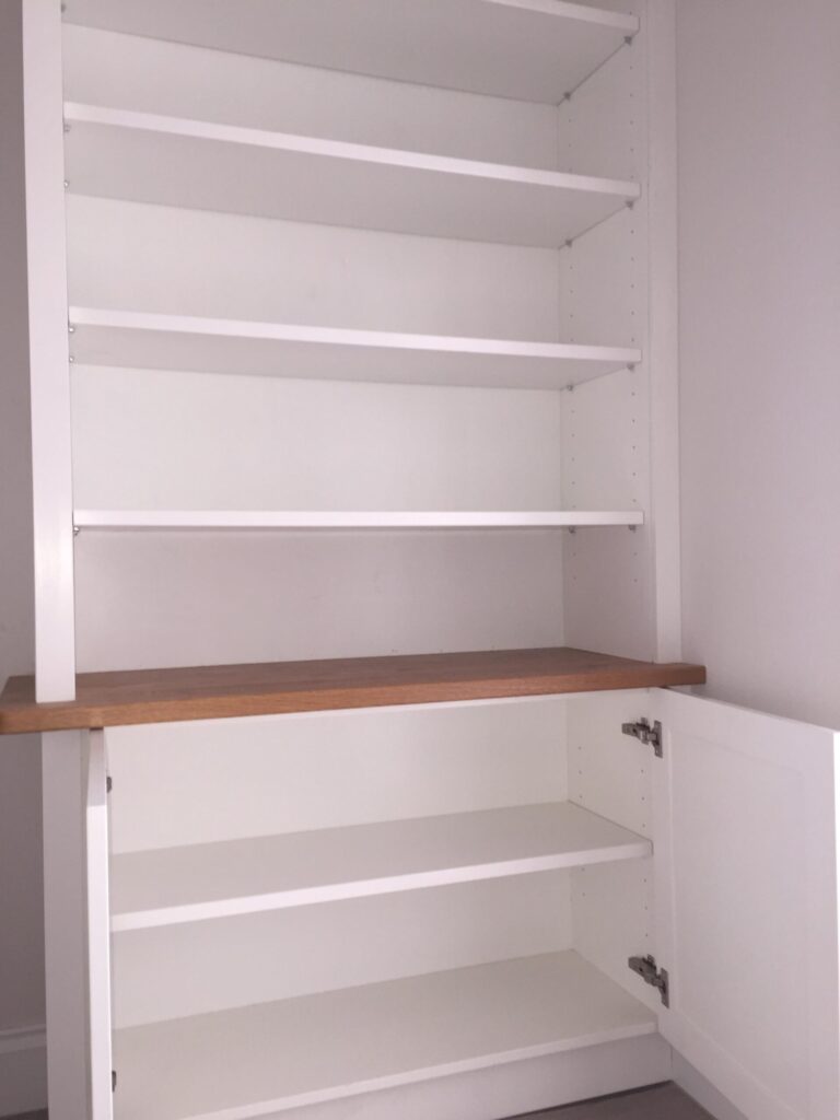 Bespoke Joinery White Fitted Bookcase With Adjustable Shelves And Open Cupboard Door Cabinets Trinity Joinery Jersey
