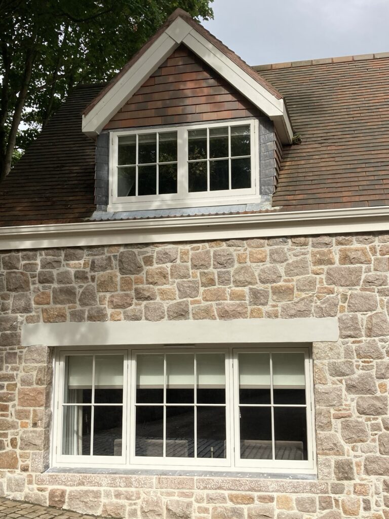 Casement Windows Painted White Finish With Glazing Bars In Stone Surround.jpg Trinity Joinery Jersey 2500