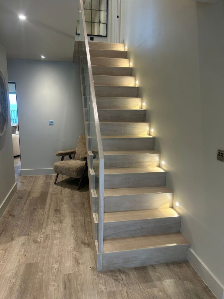Contemporary Staircase Light Ash Grey With Glass Balustrade Step Lighting Staircases Balustrade Trinity Joinery Jersey 2500