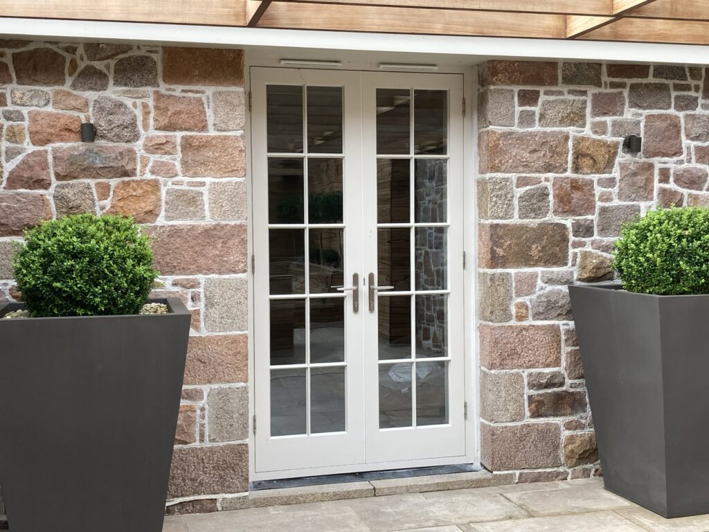 French Patio Doors With Glazing Bars Painted White Finish Within Stone Surround.jpg Exterior Doors Trinity Joinery Jersey 2500