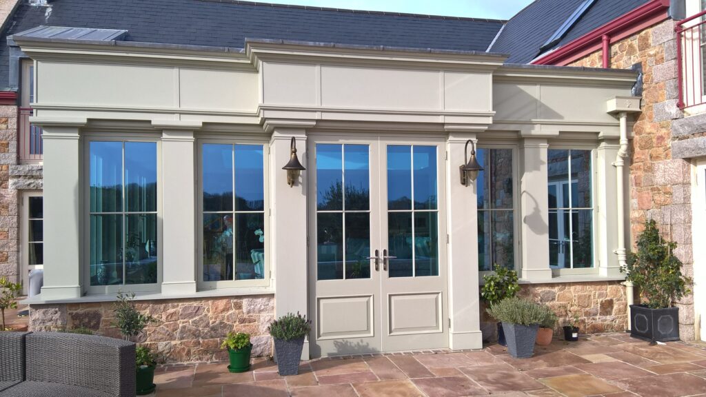 glazing exterior view of timber windows and french doors with stonework surround trinity joinery jersey 2500