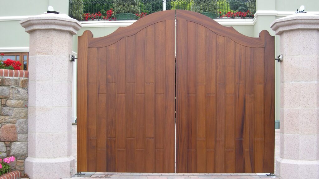 Iroko Wood Driveway Gate Scalloped Arched Top Vertical Panels Gates Trinity Joinery Jersey 2500