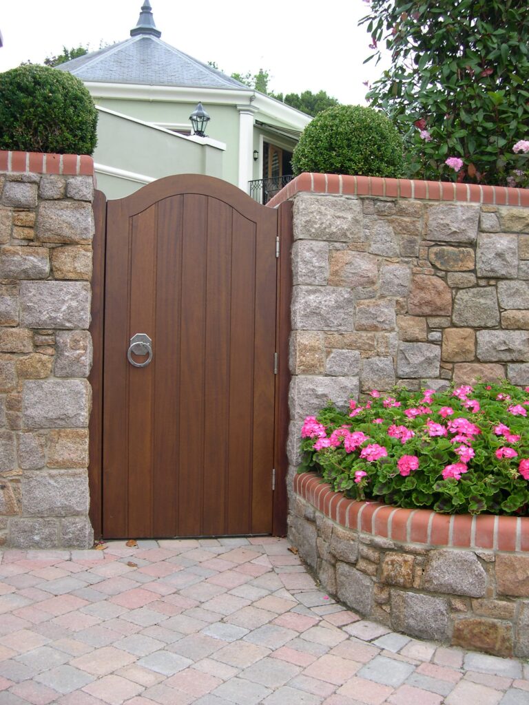 Iroko Wood Pedestrian Garden Gate Arched Top Stone Wall Paved Path Gates Trinity Joinery Jersey 2500