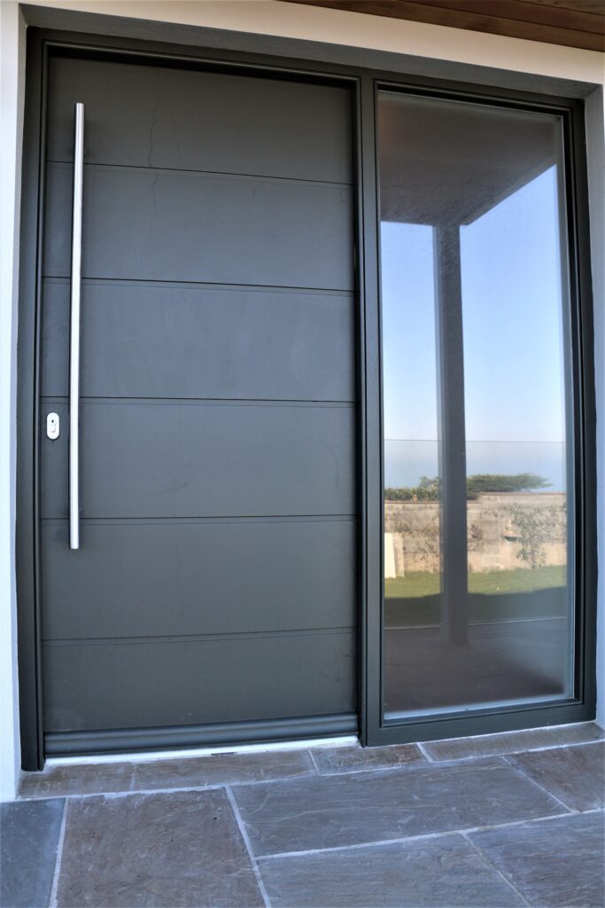 Modern Grey Front Door With Full Height Glass Side Panel And Slim Handle Jersey Exterior Doors Trinity Joinery Jersey 2500