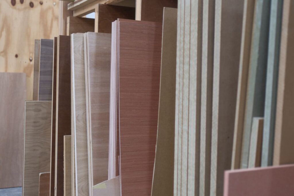 Woods & Finishes 5 Selection Of Timber And Mdf Sheets In Workshop.jpg Woods Finishes Trinity Joinery Jersey 2500
