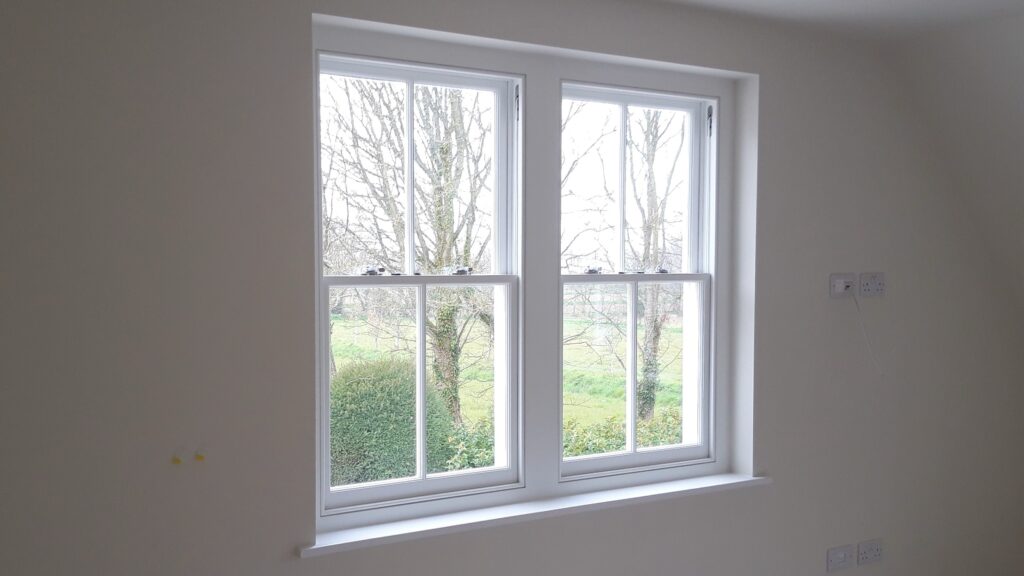 timber double sash window with georgian bars painted white interior view windows trinity joinery jersey 2500