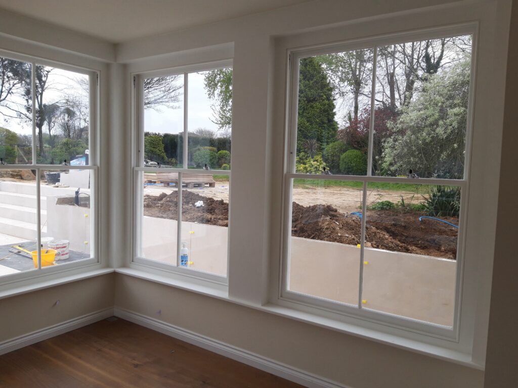 Timber Double Sash Windows With Georgian Bars Painted White Interior Corner View Trinity Joinery Jersey 2500