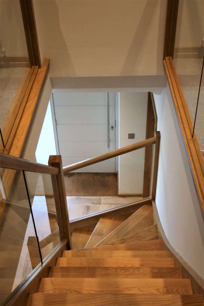 Timber Oak Staircase With Glass Balustrade Downward View Staircases Balustrade Trinity Joinery Jersey 2500