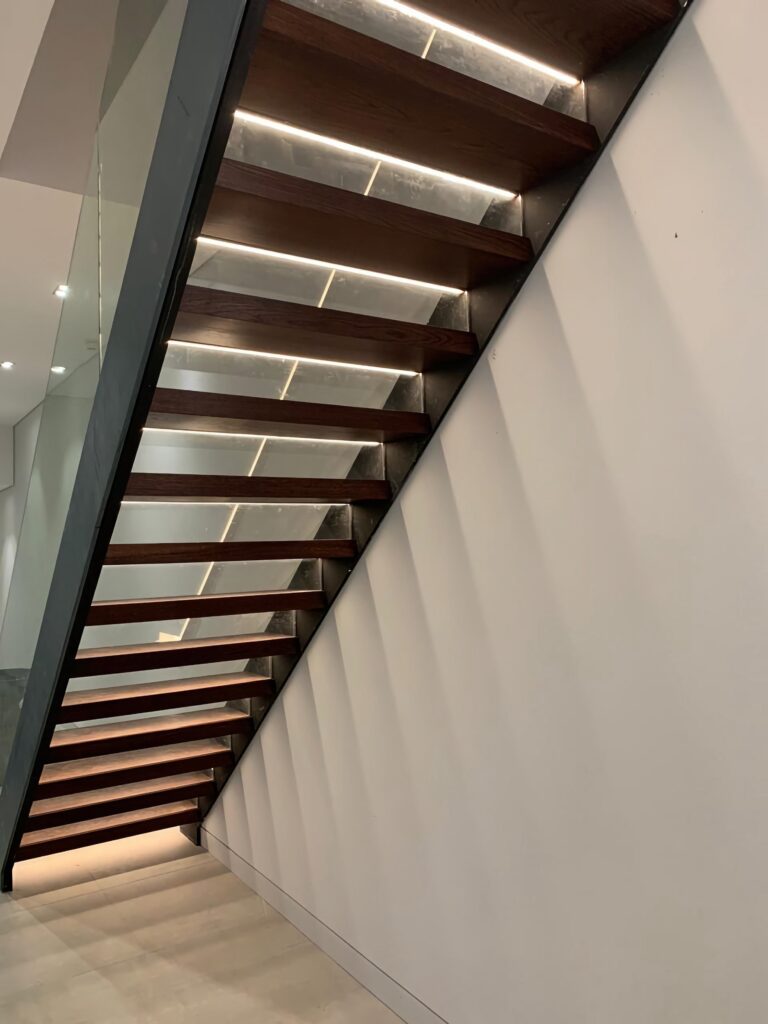 Timber Staircase With Glass Balustrade And Led Lighting Side View Staircases Balustrade Trinity Joinery Jersey 2500